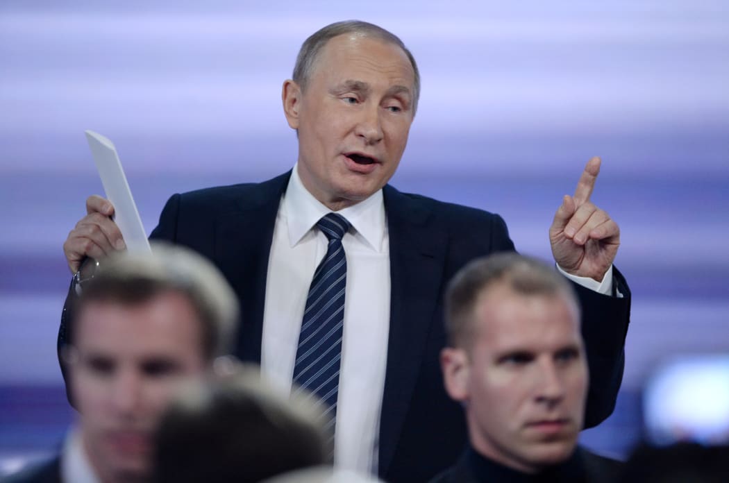 Russian President Vladimir Putin gestures as he leaves a hall after his annual press conference in Moscow on December 17, 2015. Russian President Vladimir Putin on December 17 described US Republican presidential hopeful Donald Trump as a talented and outstanding man.