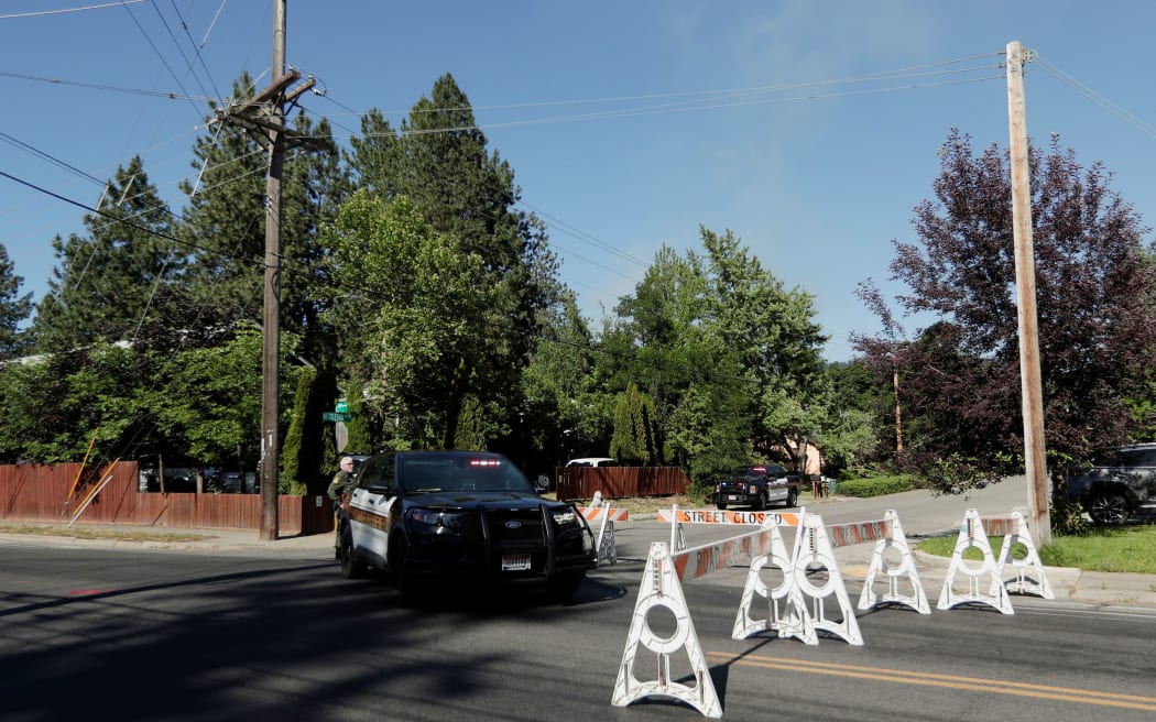Kootenai County Sheriff’s deputies block a road leading to an area where multiple firefighters were attacked.