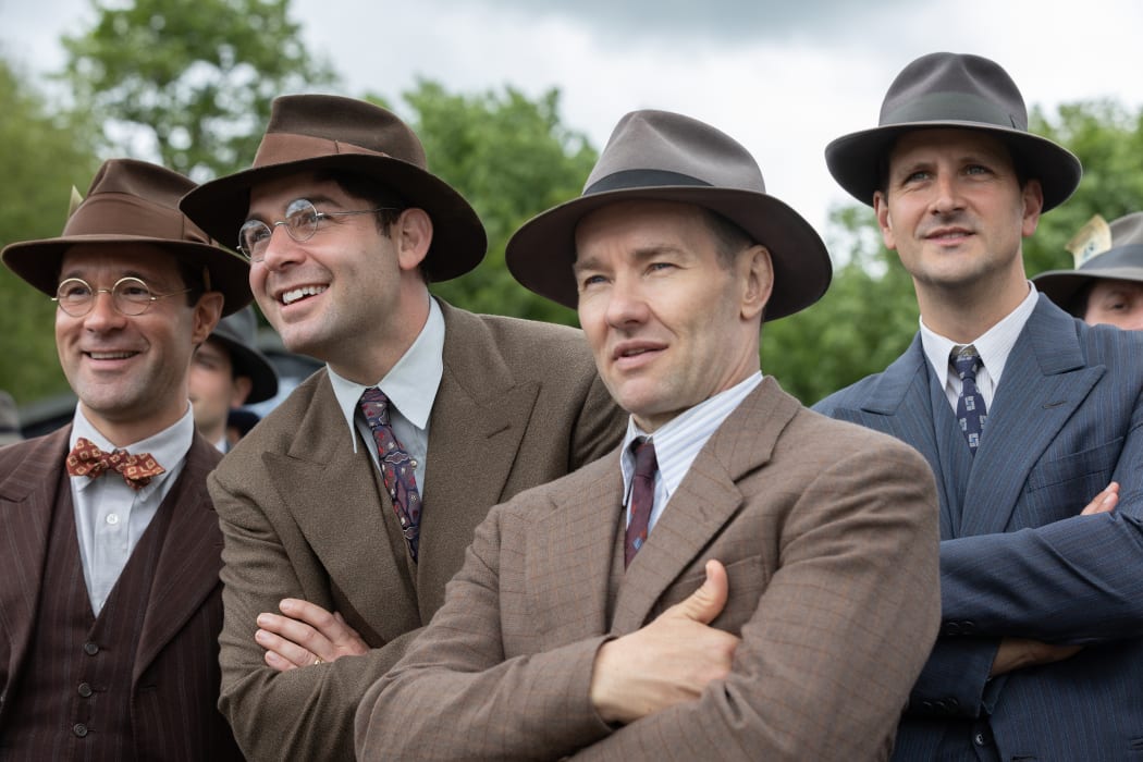 (l-r.) Chris Diamantopoulos stars as Royal Brougham, James Wolk as Coach Bolles, and Joel Edgerton as Al Ulbrickson in director George Clooney’s THE BOYS IN THE BOAT. An Amazon MGM Studios film. Photo credit: Laurie Sparham. © 2023 Metro-Goldwyn-Mayer Pictures Inc. All Rights Reserved.