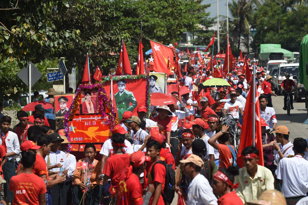 Aung San Suu Kyi's National League for Democracy supporters ride a motorcade of trishaws during a campaign in Tharketa township in Yangon