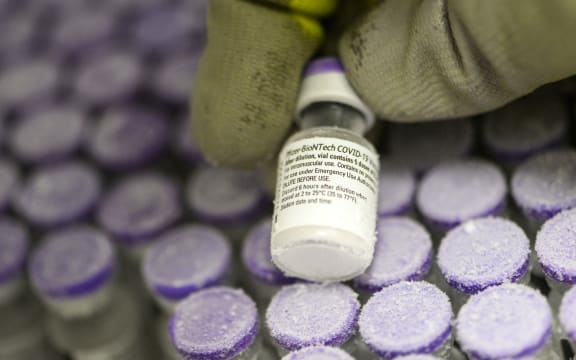 A French pharmacist holds a vial of the undiluted Pfizer-BioNTech vaccine, stored at -70 °, on 15 January, 2021.