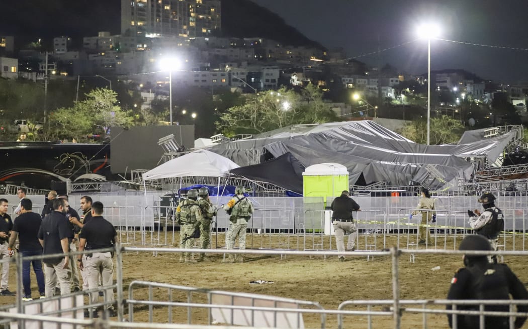 Security forces stand around a stage that collapsed due to a gust of wind during an event attended by presidential candidate Jorge Álvarez Máynez in San Pedro Garza García, on the outskirts of Monterey, Mexico, Wednesday, May 22, 2024. President Andres Manuel Lopez Obrador confirmed that multiple people were killed and at least a dozen were injured. (AP Photo/Alberto Lopez)