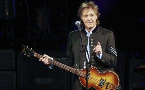 (FILES) Sir Paul McCartney performs in concert during his One on One tour at Hollywood Casino Amphitheatre on July 26, 2017 in Tinley Park, Illinois. As revealed by the Financial Times, Universal Music has been asking platforms like Spotify or Apple Music since April to ban access to its catalog to those who want to use it to enrich AI programs. Google and Universal Music are also in talks about possible licenses for AI-generated melodies and artist voices, the Financial Times also reveals. (Photo by Kamil Krzaczynski / AFP)