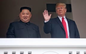 North Korea's leader Kim Jong Un (L) and US President Donald Trump (R) together during a break in their talks at the historic US-North Korea summit, at the Capella Hotel on Sentosa island in Singapore.