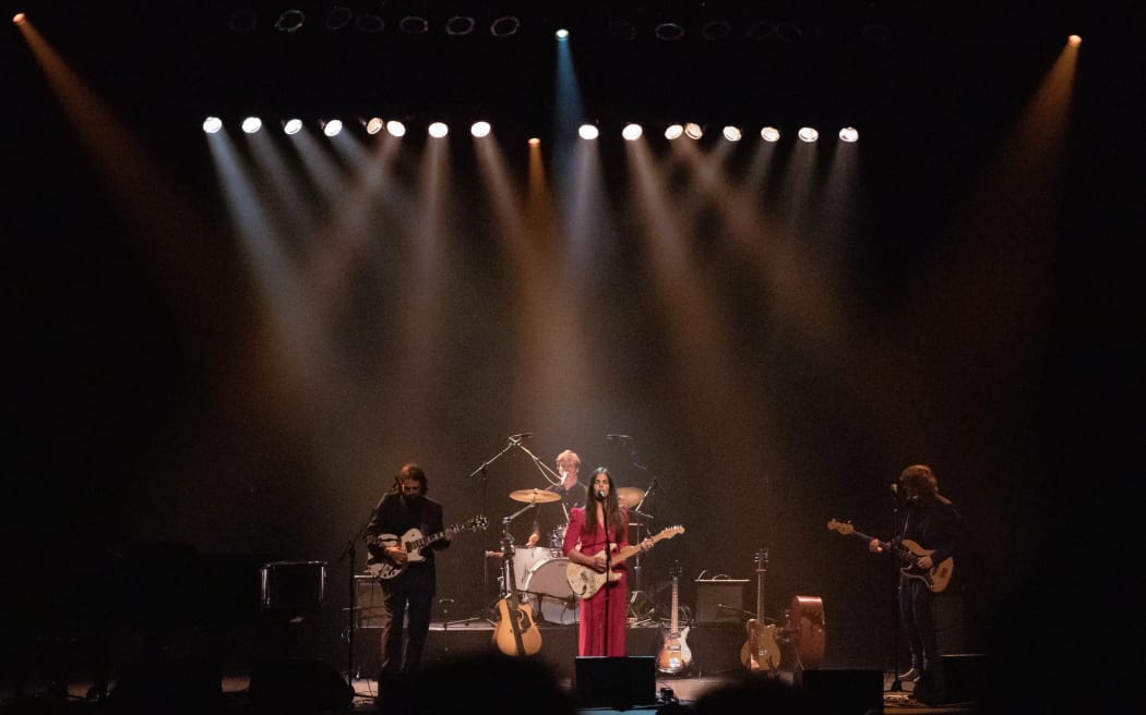 Mel Parsons and band performing at Isaac Theatre