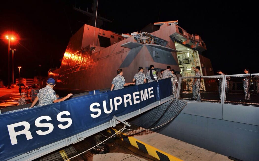 Singapore navy servicemen boarding the  frigate RSS Supreme before departing for Indonesia to take part in the search.