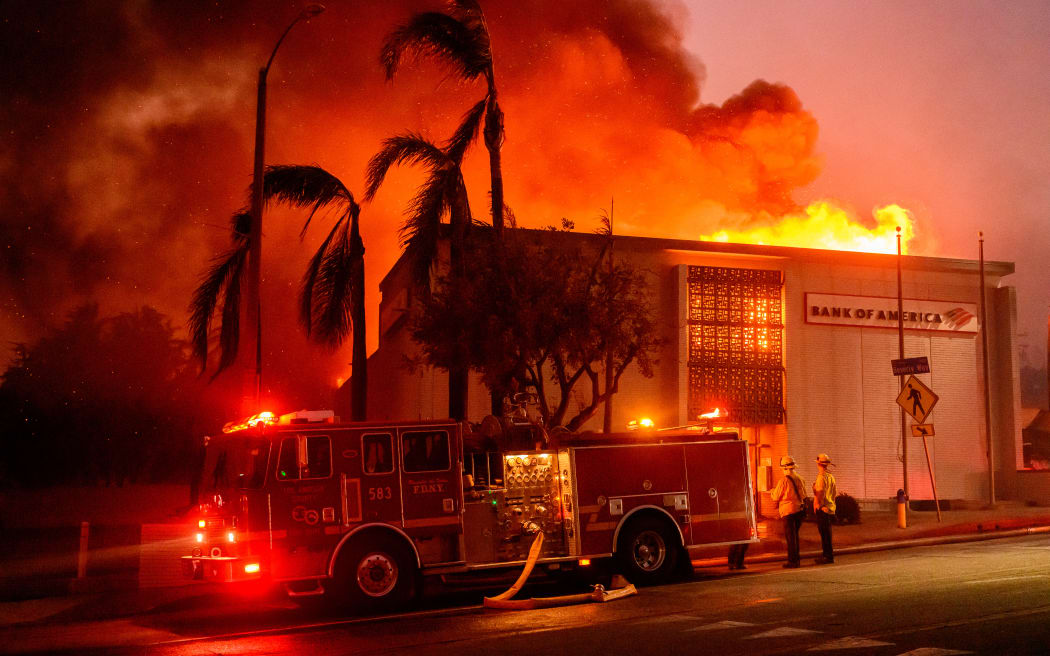 A Bank of America is fully engulfed in flames along Lake Ave. during the Eaton fire in the Altadena area of Los Angeles county, California on January 8, 2025. At least five people are now known to have died in wildfires raging around Los Angeles, with more deaths feared, law enforcement said January 8, as terrifying blazes leveled whole streets, torching cars and houses in minutes.
More than 1,000 buildings have burned in multiple wildfires that have erupted around America's second biggest city, forcing tens of thousands of people from their homes. (Photo by JOSH EDELSON / AFP)