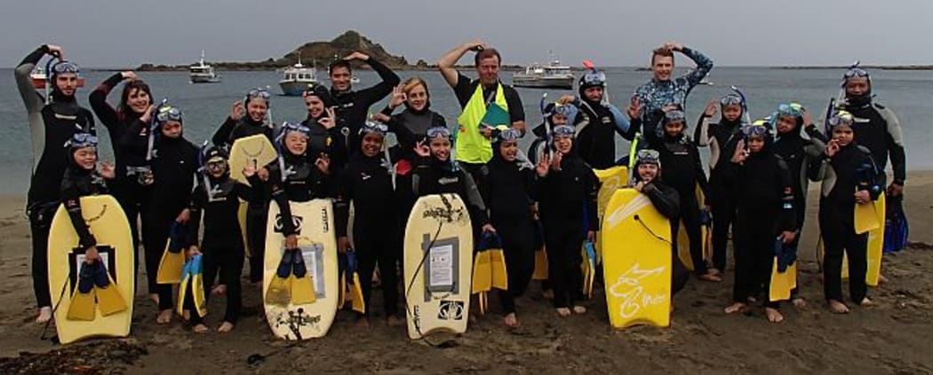 Students and a team of adult helpers, made up of the teacher, volunteers and parent helpers - practise their 'okay' signs before getting in the water. The dive signal for OK is a small closed circle made with thumb and forefinger, or a large circle made by touching a hand to the top of the head.