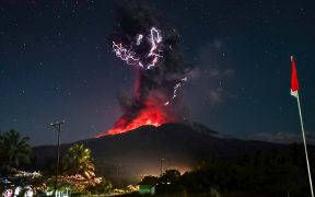 This handout photo taken and released on August 1, 2025 by Indonesia's Geological Agency shows Mount Lewotobi Laki-Laki spewing lava and volcanic ash up to approximately 10 kilometres high during its eruption as observed from the monitoring post in East Flores, in East Nusa Tenggara province. A volcano in eastern Indonesia erupted on August 1, belching an ash tower 10 kilometres (6.2 miles) into the sky, the country’s volcanology agency said, weeks after another huge eruption triggered dozens of flight cancellations to and from Bali. (Photo by Indonesia's Geological Agency / AFP) / RESTRICTED TO EDITORIAL USE - MANDATORY CREDIT  "AFP PHOTO / INDONESIA'S GEOLOGICAL AGENCY" - HANDOUT - NO MARKETING NO ADVERTISING CAMPAIGNS - DISTRIBUTED AS A SERVICE TO CLIENTS