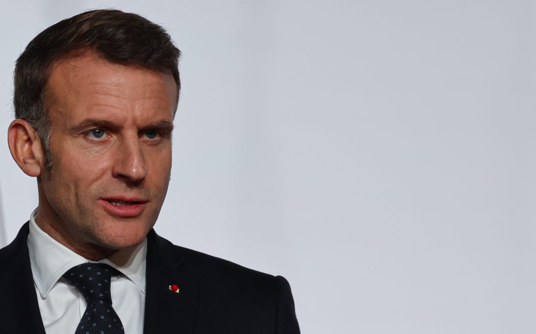 France's President Emmanuel Macron delivers a press conference upon the signing of the declaration on deploying post-ceasefire force in Ukraine during the Coalition of the Willing summit on security guarantees for Ukraine, at the Elysee Palace in Paris on January 6, 2026. The summit of the group of Ukraine supporters dubbed the "Coalition of the Willing" is the latest of several meetings planned for the new year as diplomatic efforts to end Europe's deadliest conflict since World War II have gained pace in recent weeks. (Photo by Ludovic MARIN / POOL / AFP)