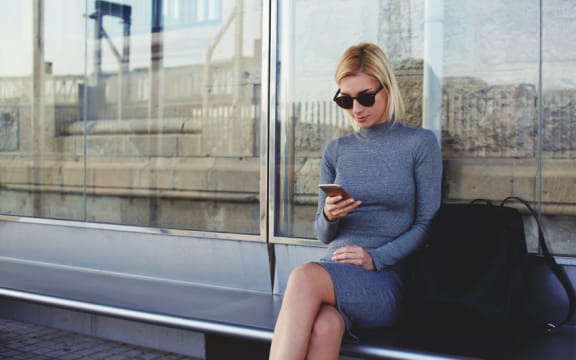 Young woman at bus stop