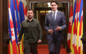 Ukrainian President Volodymyr Zelensky (L) and Canadian Prime Minister Justin Trudeau arrive at a signing ceremony on Parliament Hill in Ottawa on September 22, 2023. (Photo by Patrick Doyle / POOL / AFP)