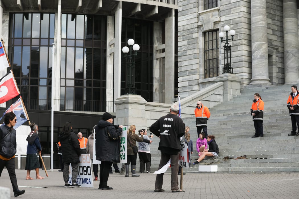 Protestors advanced beyond the barricade towards Parliament House to throw green imitation 1080 pellets at its doors and placed dead birds on the steps. 12 September 2018