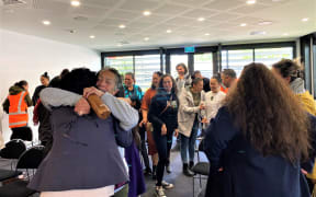 Ngati Oneone chair Charlotte Gibson embraces Gisborne District Council chief executive Nedine Thatcher Swann after a vote in favour of Maori wards.