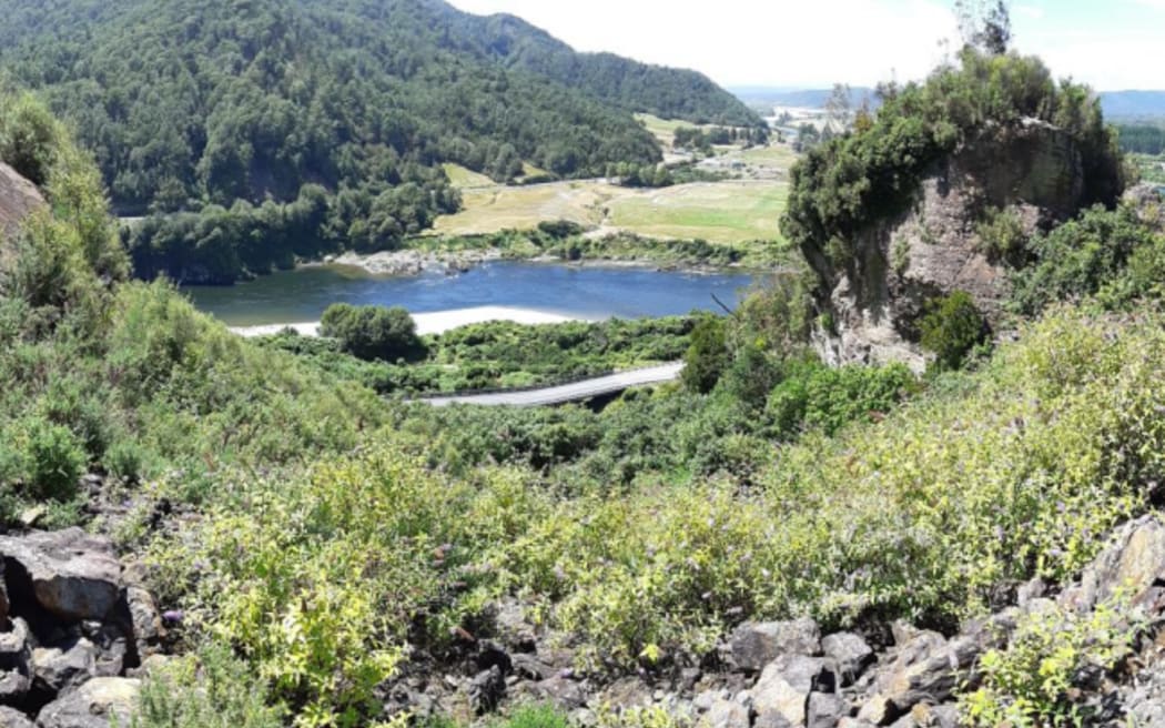 A view of the abandoned Kiwi Point Quarry, with the rock outcrop dubbed a hazard, right, and the Kiwi Point rail overbridge and State Highway 7, bottom.