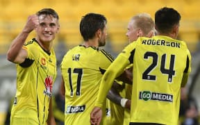 Phoenix's Dylan Fox (L) celebrates a goal during the A-League - Phoenix v Newcastle football match.