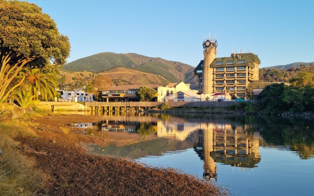 Looking across the Maitai River to Civic House with the new library site to the left of the clocktower