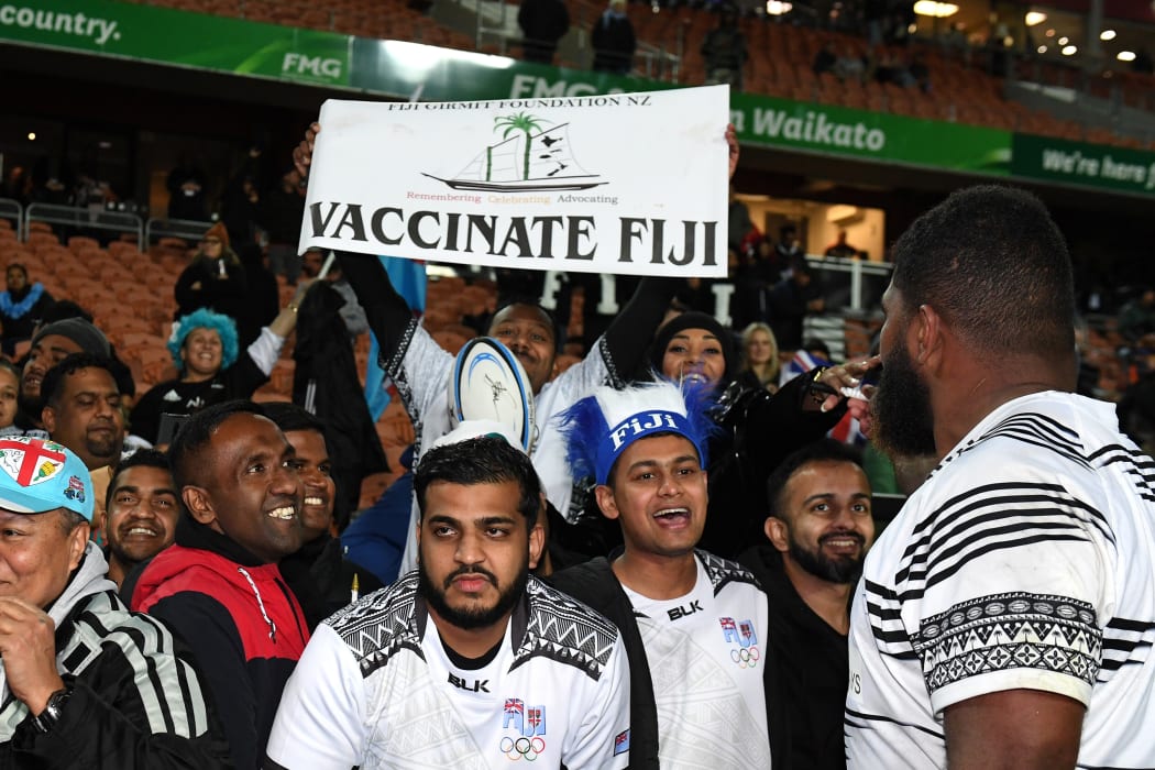 Fans at the Fiji vs All Blacks test in Hamilton display a sign promoting Covid-19 vaccinations.
