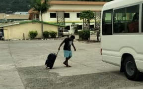A refugee boards the bus to his new community accommodation shortly before being returned to his hotel.