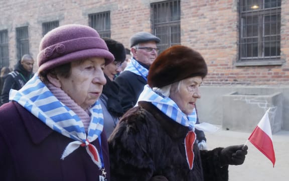 Holocaust survivors attend a wreath laying at the death wall at the memorial site of the former German Nazi death camp Auschwitz.