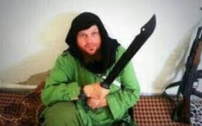 In this image supplied to the ABC, Mark Taylor is pictured posing with a sword.