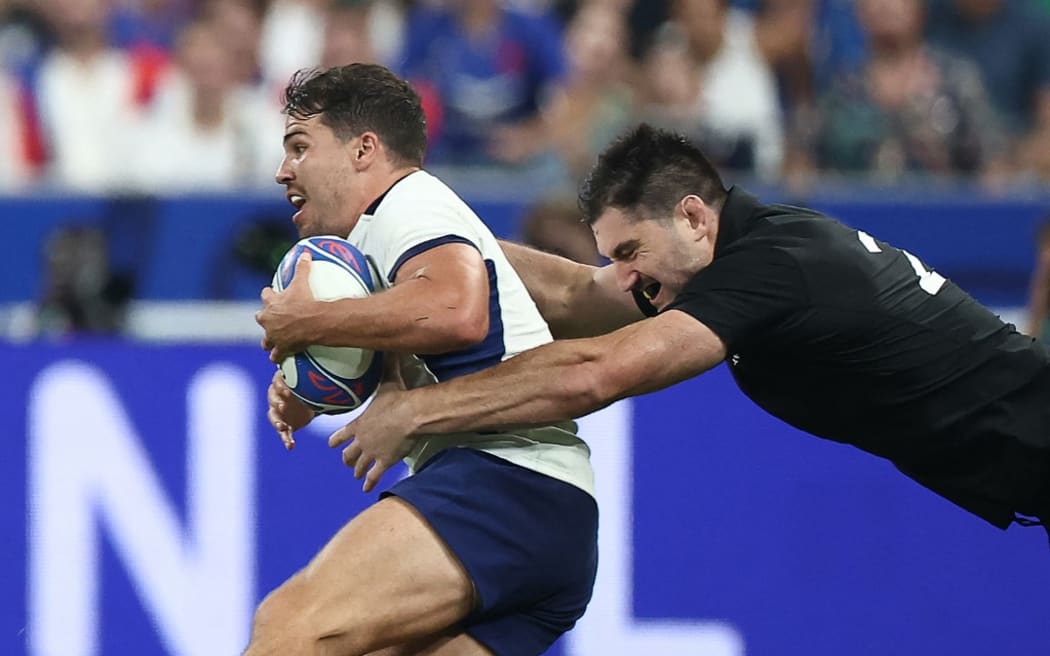 New Zealand's flanker Luke Jacobson (R) tackles France's scrum-half and captain Antoine Dupont during the France 2023 Rugby World Cup Pool A match between France and New Zealand at the Stade de France in Saint-Denis, on the outskirts of Paris on September 8, 2023. (Photo by FRANCK FIFE / AFP)
