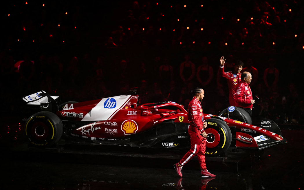 (From L) Ferrari's British driver Lewis Hamilton, Ferrari's French team principal Frederic Vasseur and Ferrari's Monaco driver Charles Leclerc at the 2025 Formula 1 season launch in London.