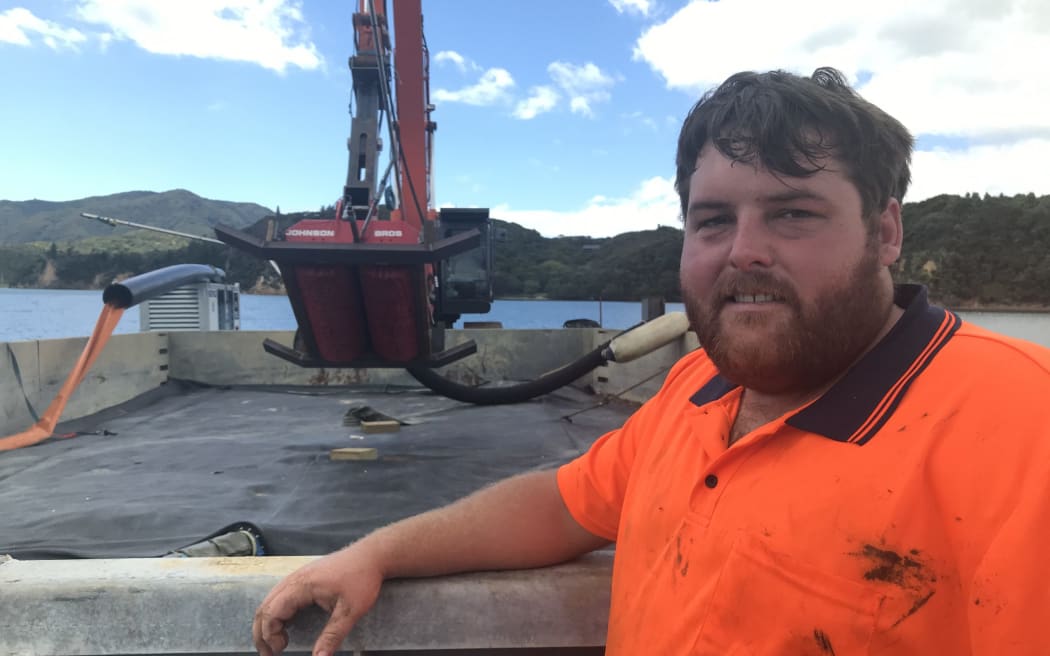 Bay of Islands' Andrew Johnson with his groundbreaking mechanical suction dredge in Omākiwi Cove.