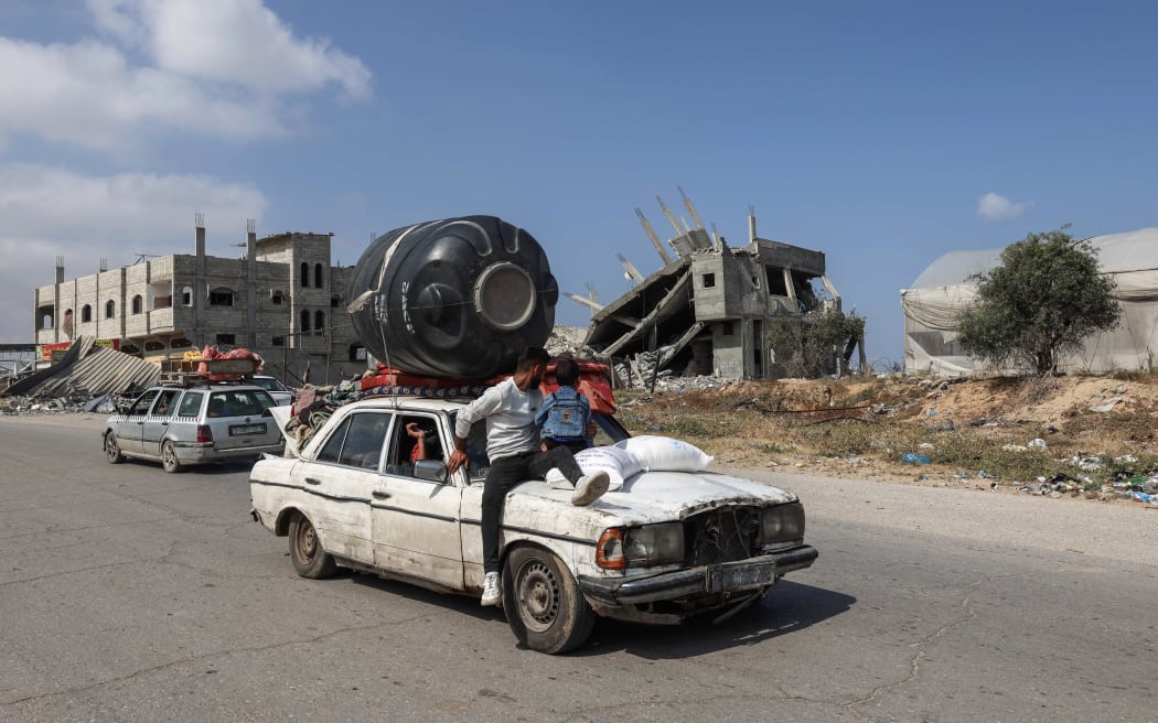 Displaced Palestinians leave southern Gaza's Rafah in a jam-packed car, heading for the Khan Yunis area on April 11, 2024, amid the ongoing conflict between Israel and the Palestinian Hamas militant group. (Photo by MOHAMMED ABED / AFP)