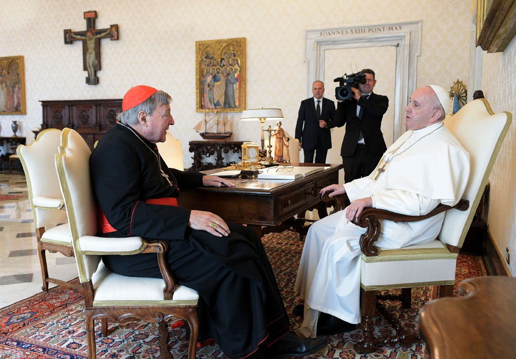 Pope Francis talks with Cardinal George Pell