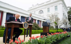 US President Donald Trump signs an executive order after delivering remarks on reciprocal tariffs during an event in the Rose Garden entitled "Make America Wealthy Again" at the White House in Washington, DC, on 2 April 2025.