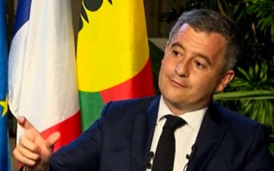 French Home Affairs and Overseas minister Gérald Darmanin  speaks to local media.