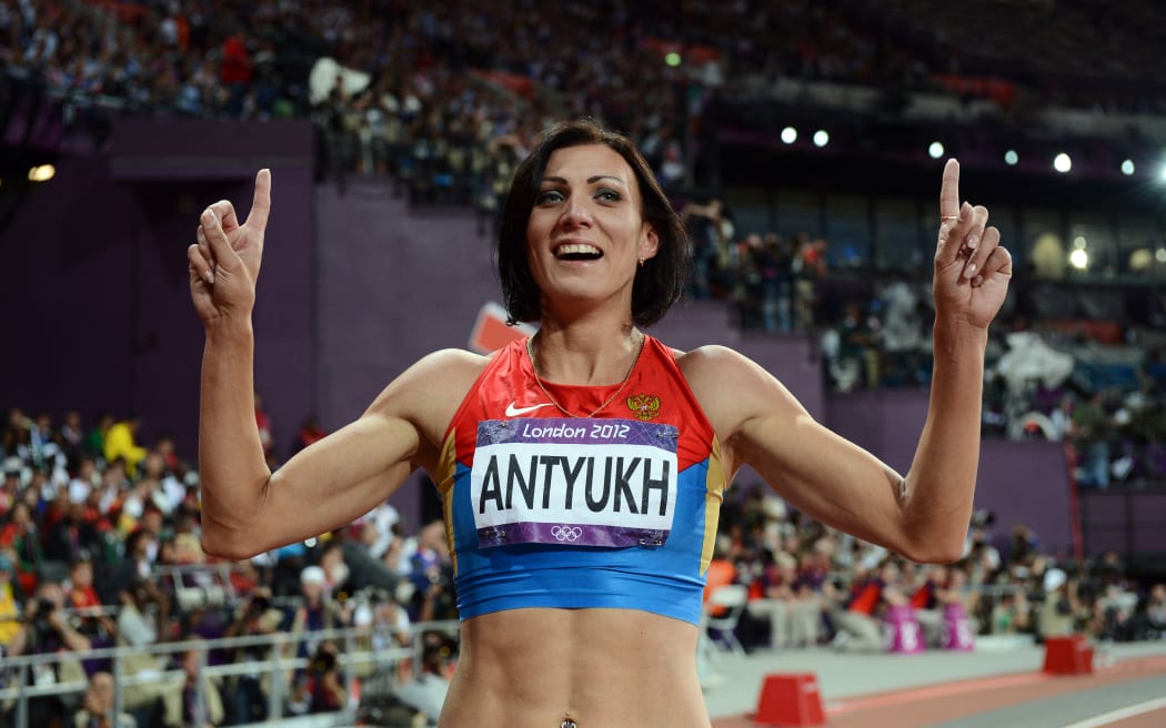 Russia's Natalya Antyukh celebrates after winning the women's 400m hurdles final at the athletics event of the London 2012 Olympic Games on August 8, 2012 in London. AFP PHOTO / FRANCK FIFE (Photo by FRANCK FIFE / AFP)