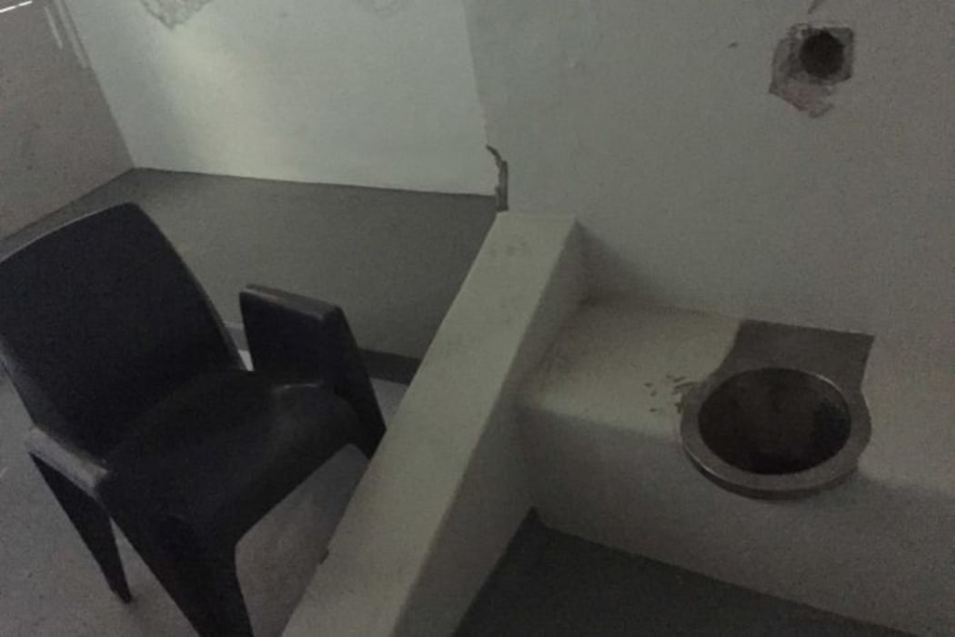 A basic toilet and plastic chair inside a cell in the isolation wing of the Don Dale Youth Detention Centre.