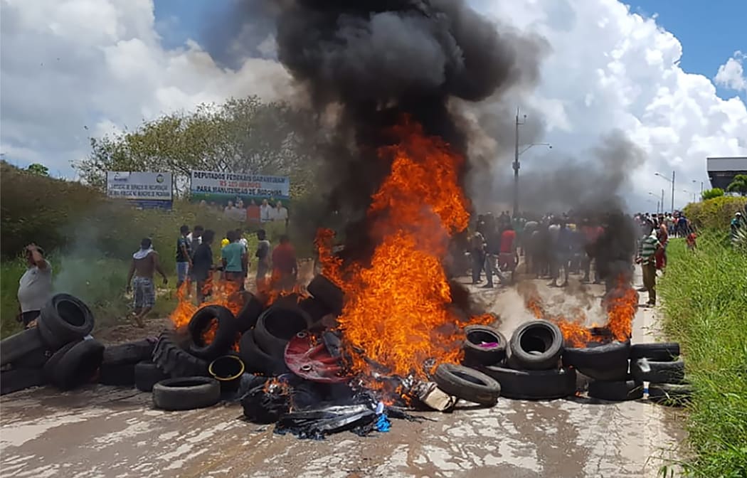 Residents of the Brazilian border town of Pacaraima burn tyres and belongings of Venezuelans immigrants after attacking their two main makeshift camps, leading them to cross the border back into their home country.