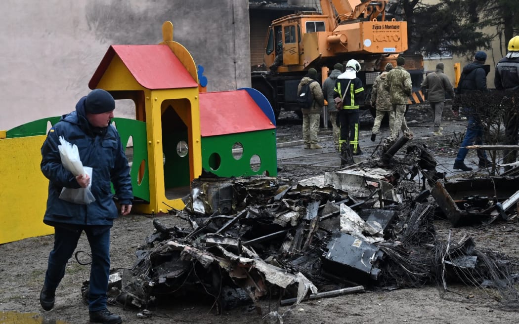 Firefighters work near the site where a helicopter crashed near a kindergarten in Ukraine.