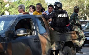 Ivorian security forces evacuate people after heavily armed gunmen opened fire on March 13, 2016 at a hotel in the Ivory Coast beach resort of Grand-Bassam.
