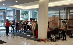 Nota Bene sing Christmas Carols from the lobby of RNZ House in Wellington.