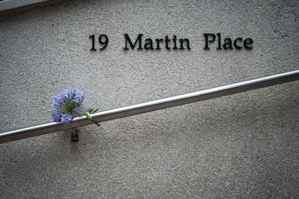 Flowers are left near the Martin Place cafe in Sydney where a 16-hour siege took place, ending with three dead.