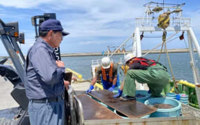 Toru Takahashi (left) says the the fear has already hurt business