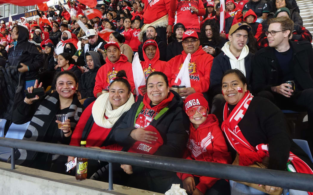 Fans wave the Tonga flag.