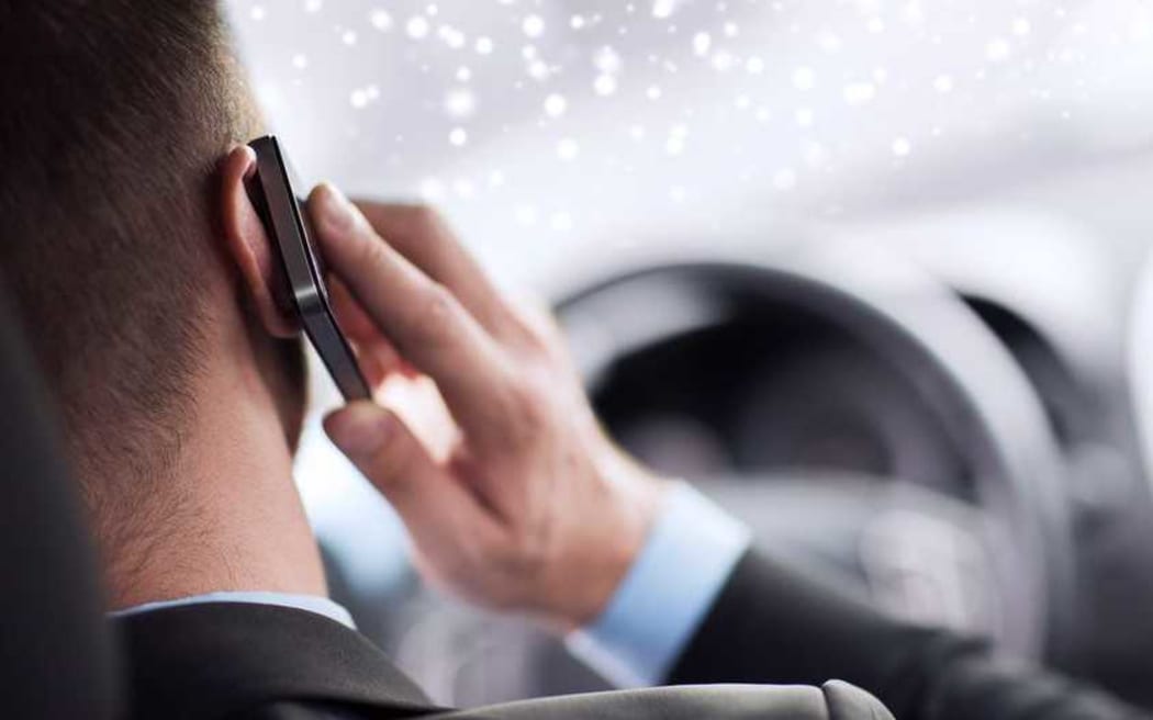 Driving and phoning at the same time.