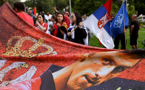 Members of the local Serbian community protest outside a government detention centre where Serbia's tennis champion Novak Djokovic is staying in Melbourne, after he was dramatically refused official entry to Australia over his Covid-19 vaccine status.