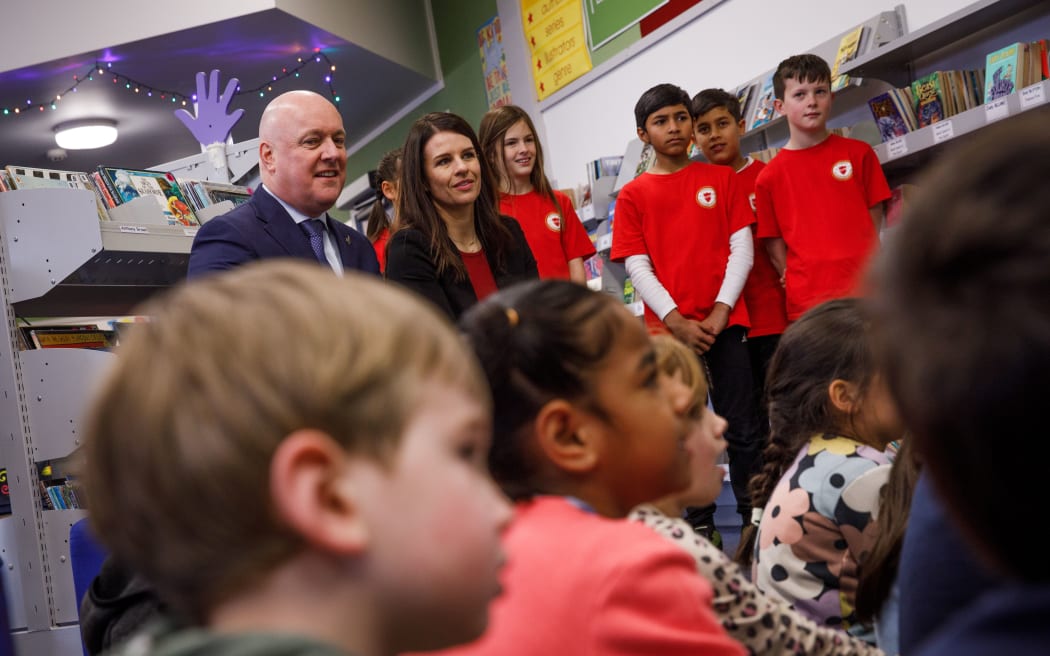 Christopher Luxon and Erica Stanford visiting students at Silverstream Primary School ahead of announcing mandatory reading, writing and maths tests for primary schools.