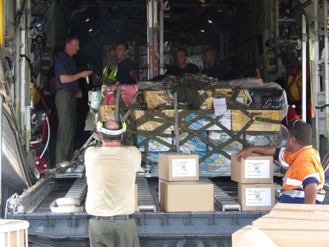 Crew from a Royal New Zealand Air Force C-130 Hercules aircraft begin to unload the estimated three tonnes of textbooks donated to Fiji’s cyclone-damaged schools.