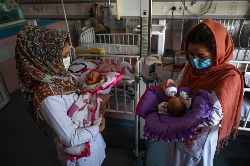 Nurses feed newborn babies whose mothers were killed in the attack on a maternity ward in Kabul on 12 May.