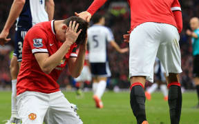 Patrick McNair of Manchester United looks dejected.