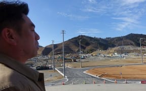 Onagawa Mayor Yoshiaki Suda surveys reconstruction work.