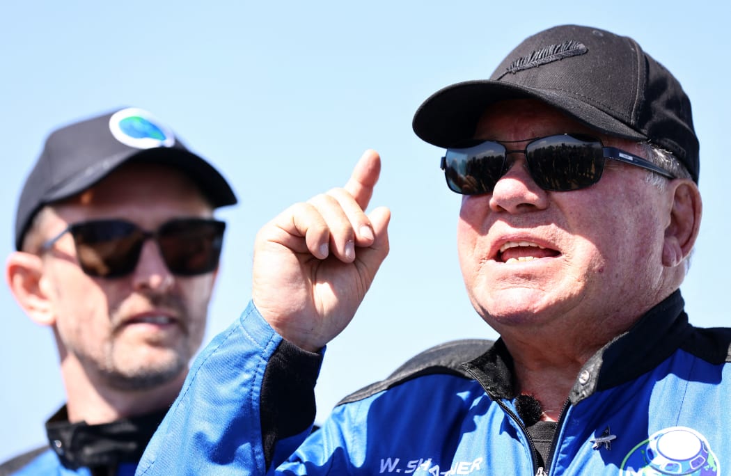 Star Trek actor William Shatner (R) speaks to media on the landing pad of Blue Origin's New Shepard as Planet Labs co-founder Chris Boshuizen looks on. The pair flew into space on October 13, 2021 near Van Horn, Texas.