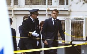French President Emmanuel Macron (R) arrives at the Lycee Gambetta high school in Arras, northeastern France on 13 October, 2023, after a teacher was killed and two other people severely wounded in a knife attack. A man of Chechen origin stabbed to death a teacher and severely wounded two other adults, with prosectors opening a probe into a suspected act of terror.